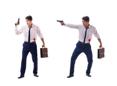 Businessman wounded in gun fight isolated on whiteの写真素材