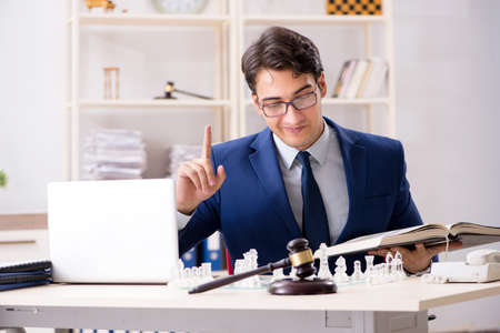 Young lawyer playing chess to train his court strategy and tactiの写真素材