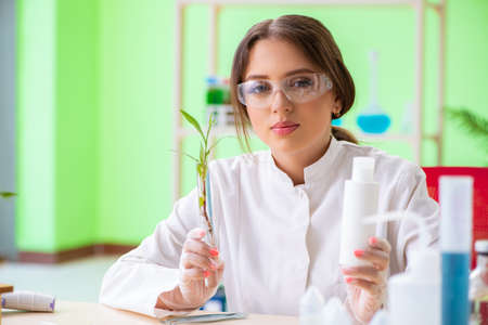 Beautiful female biotechnology scientist chemist working in labの写真素材