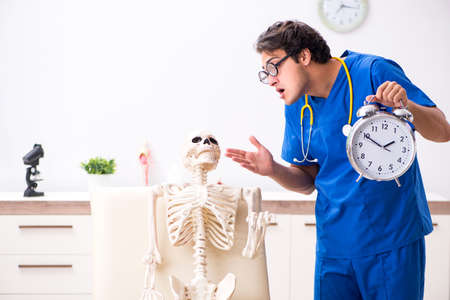 Funny doctor with skeleton in hospitalの写真素材