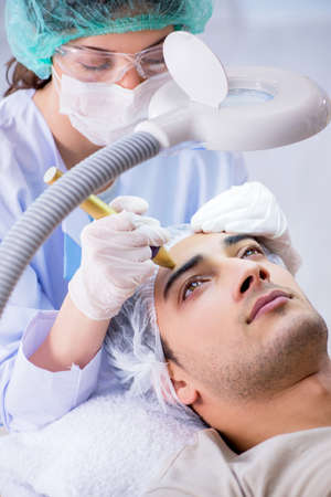 Man visiting dermatologyst for laser scar removalの写真素材