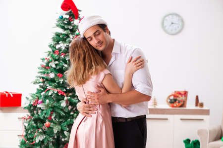 Young pair celebrating christmas at homeの写真素材