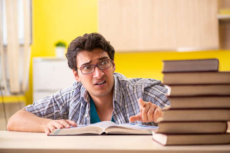 Student preparing for exam sitting at the kitchenの写真素材