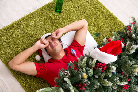 Young man drunk at home after christmas party