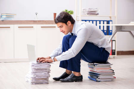 Extremely busy employee working in the office