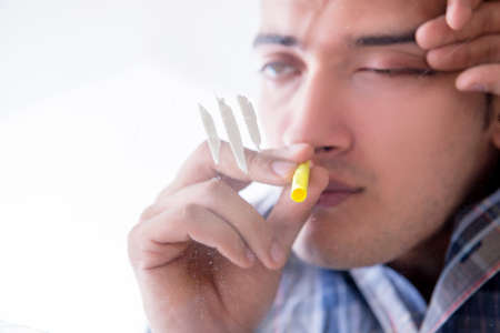 Drug addict sniffing cocaine narcotic