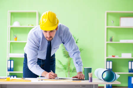 Young male architect working at the project