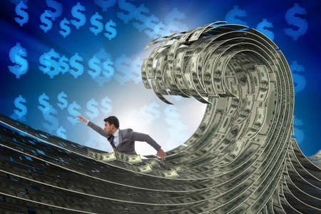 Businessman swimming in the sea of dollar moneyの写真素材