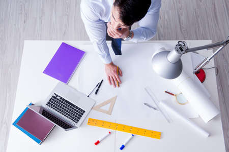 Engineer working on new project drawingsの写真素材