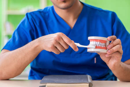 Man dentist working on new teeth implant