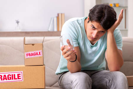 Man opening fragile parcel ordered from internet