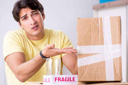 Man moving house and relocating with fragile itemsの写真素材