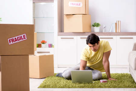 Man moving house and relocating with fragile items