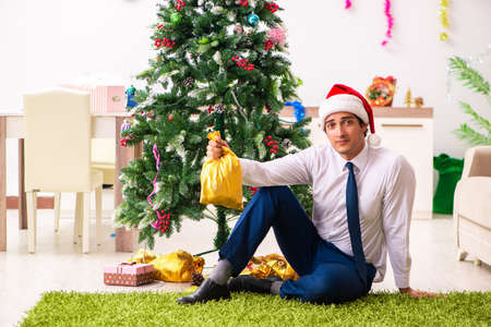 Employee businessman celebrating christmas in officeの写真素材