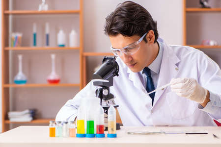 Young handsome biochemist working in the lab