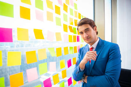 Young handsome employee with many conflicting prioritiesの写真素材