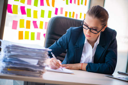 Beautiful female employee with many conflicting prioritiesの写真素材