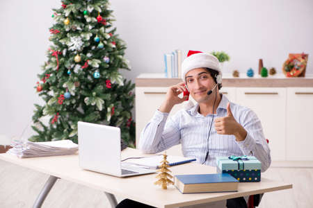 Telesales operator during christmas sale on the phoneの写真素材
