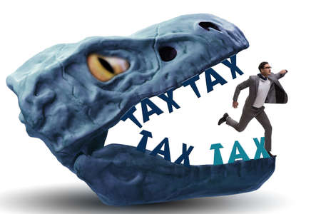 Businessman in the jaws of high taxesの写真素材