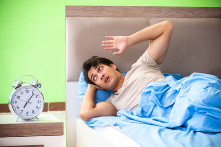 Man having trouble with his sleepの写真素材