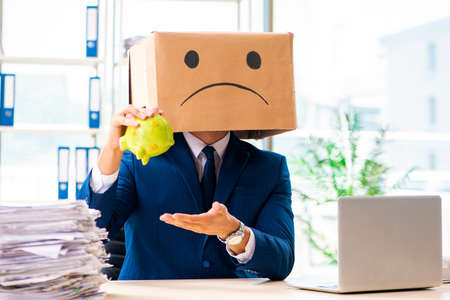 Unhappy man with box instead of his headの写真素材