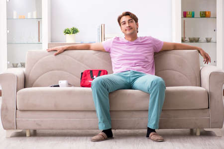 Sick man at home with first aid kitの写真素材