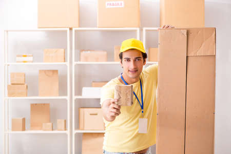 Handsome contractor working in box delivery relocation serviceの写真素材