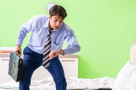 Young businessman employee late for officeの写真素材