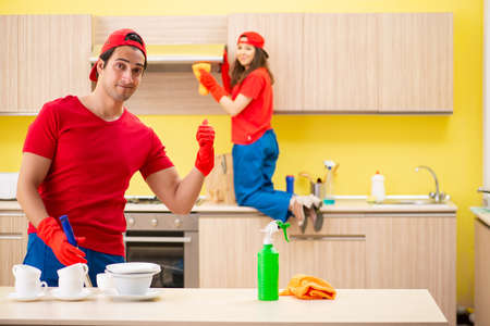 Cleaning professional contractors working at kitchenの写真素材