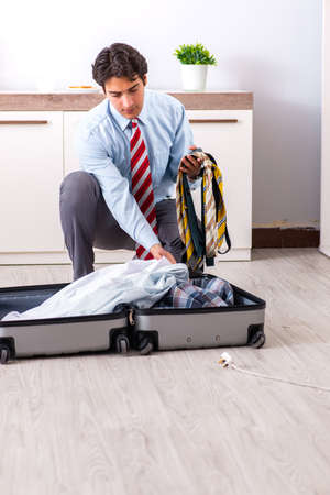 Young handsome businessman preparing for tripの写真素材
