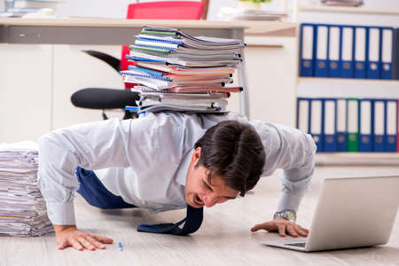 Extremely busy employee working in the officeの写真素材