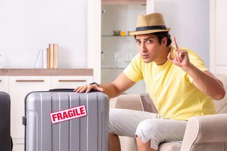 Man going on vacation with fragile suitcasesの写真素材