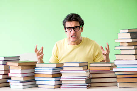 Student with too many books to read before examの写真素材