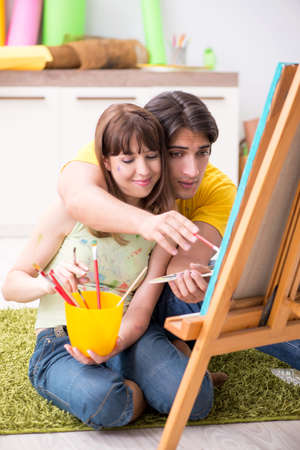 Young couple enjoying painting at homeの写真素材