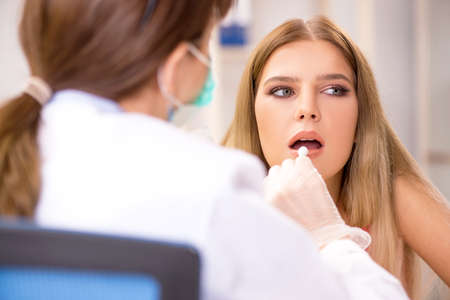 Young beautiful woman visiting female dentist