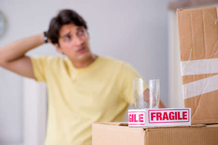 Man moving house and relocating with fragile itemsの写真素材