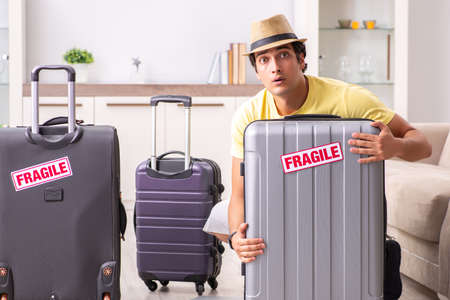 Man going on vacation with fragile suitcasesの写真素材