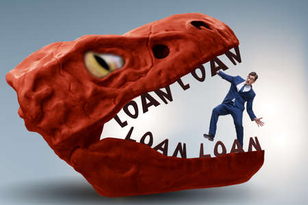 Businessman in the jaws of debt and loanの写真素材