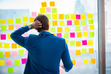 Young handsome employee with many conflicting prioritiesの写真素材