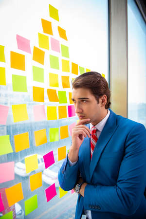 Young handsome employee with many conflicting prioritiesの写真素材