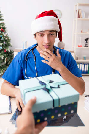 Doctor with gift box in the hospitalの写真素材