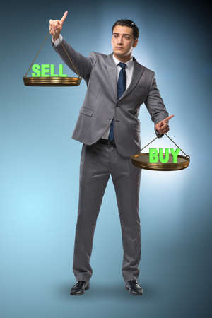 Businessman choosing between buying and sellingの写真素材