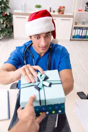 Doctor with gift box in the hospitalの写真素材