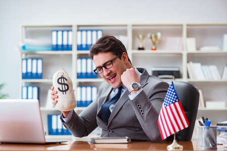 Businessman with American flag in officeの写真素材