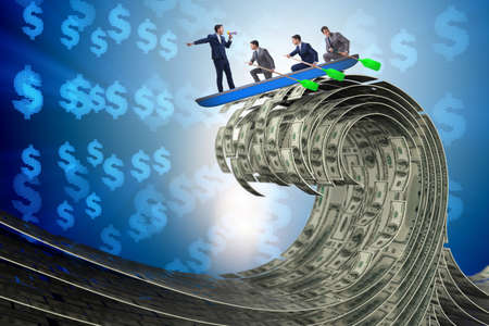 Businessman leading his team through dollar seaの写真素材