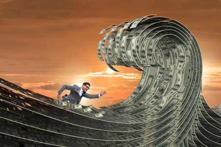 Businessman swimming in the sea of dollar moneyの写真素材