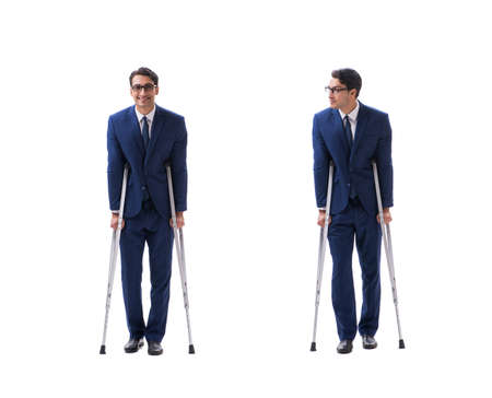 Businessman walking with crutches isolated on white backgroundの写真素材