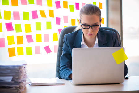 Beautiful female employee with many conflicting prioritiesの写真素材