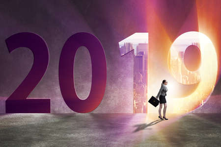 Businesswoman in the concept of transition to year 2019の写真素材
