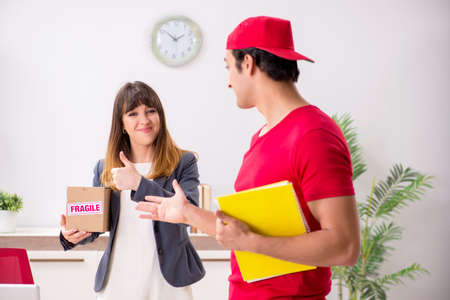 Courier delivering parcel to the officeの写真素材